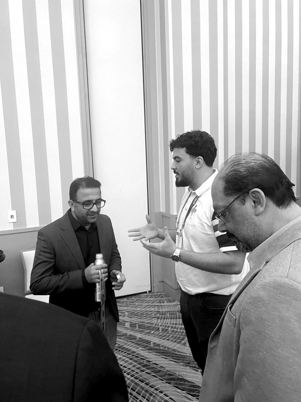 Tarik Salih in conversation with two people at CES