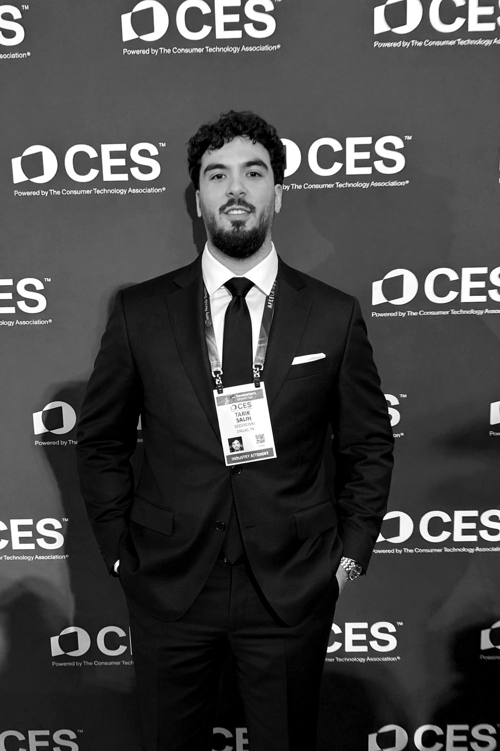 Tarik Salih in a suit in front of the CES backdrop