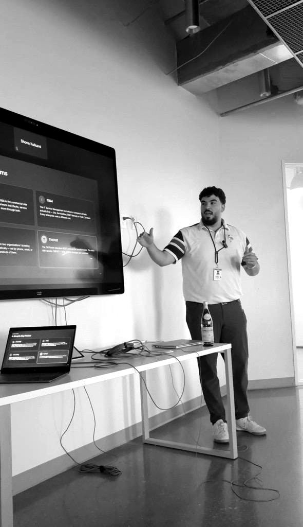 Tarik Salih presenting in front of a screen at Infosys